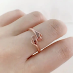 Rose gold embrace ring worn on hand
